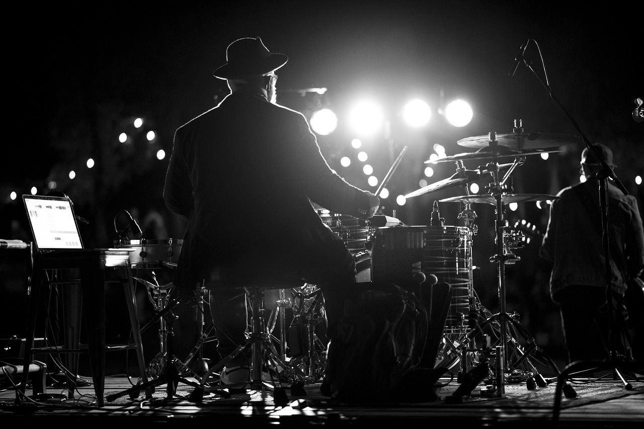 A drummer performs passionately on stage, embodying the essence of acoustic drumming. Is Acoustic Drumming for you? Let'