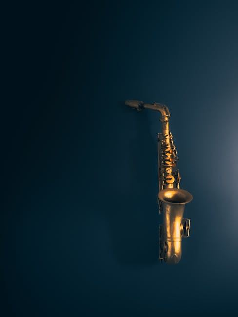 A golden saxophone hanging against a dark blue wall, symbolizing music and creativity.