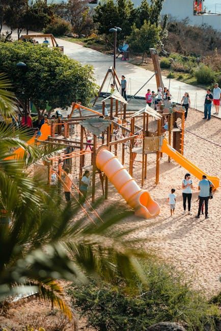 A vibrant playground with slides and climbing structures, showcasing a community park setting.
