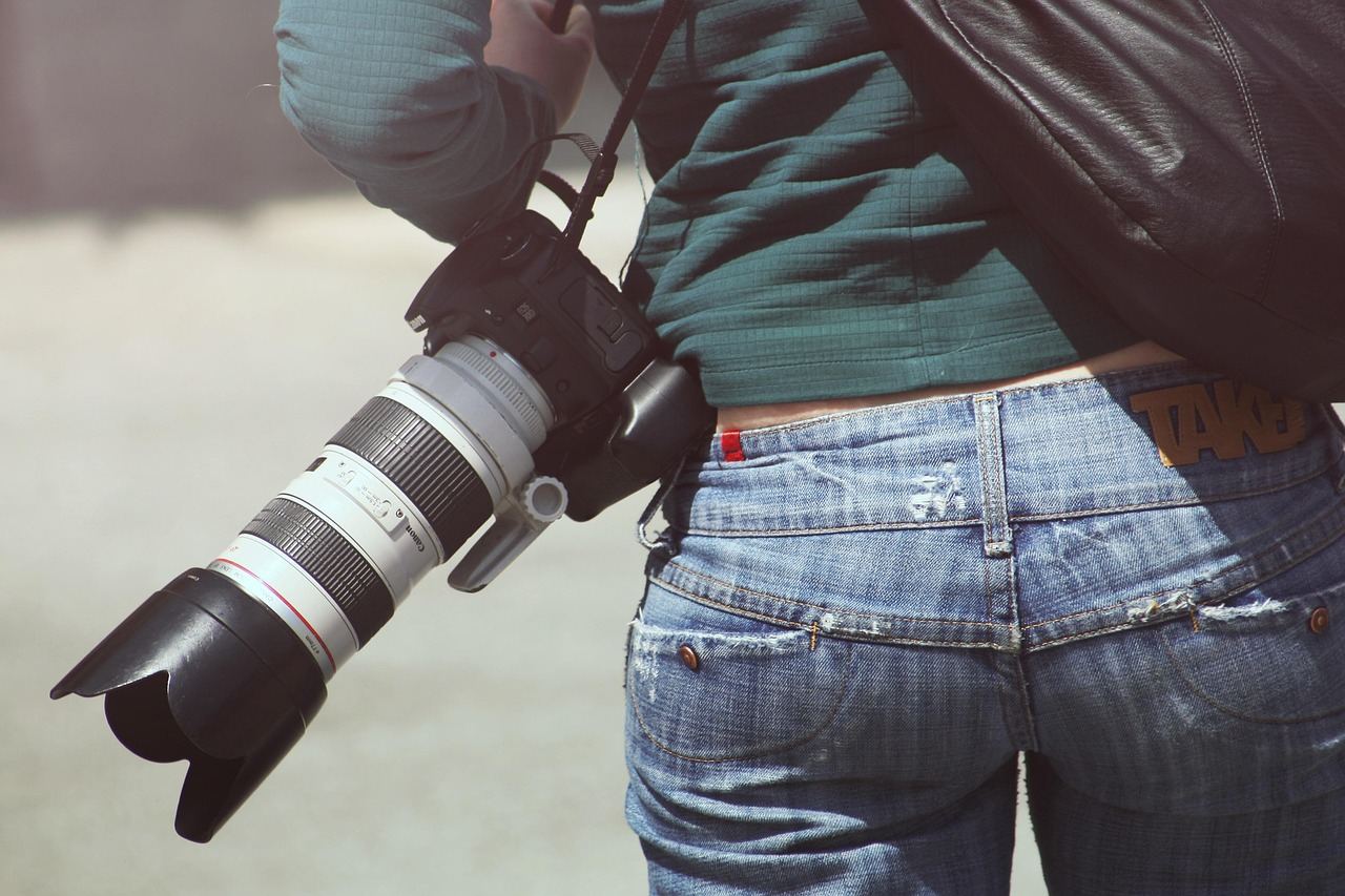 A photographer with a camera slung over their shoulder, exploring the world of event photography.