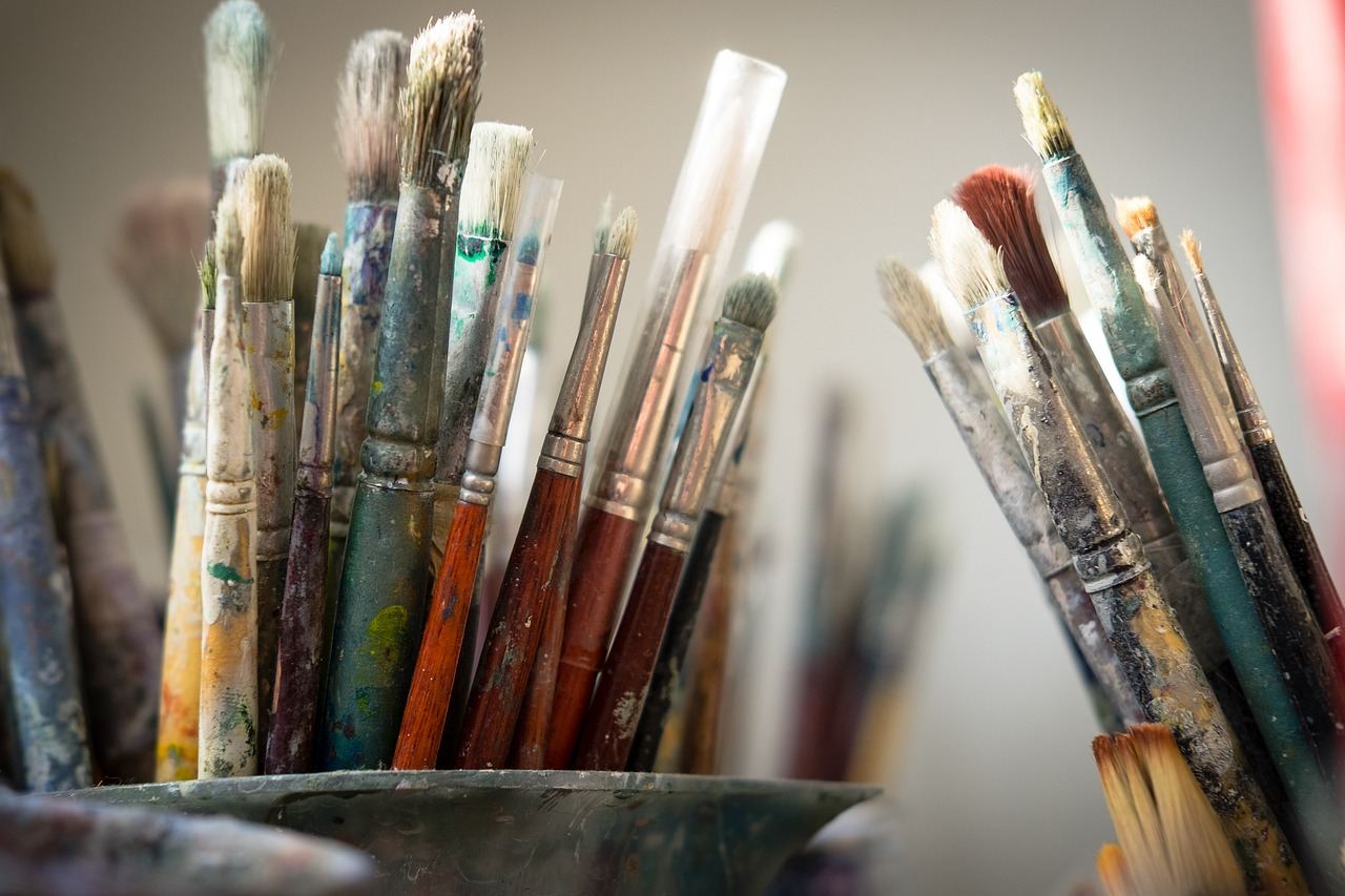 A collection of vibrant paintbrushes arranged neatly, showcasing various sizes and colors, perfect for comic art creation.