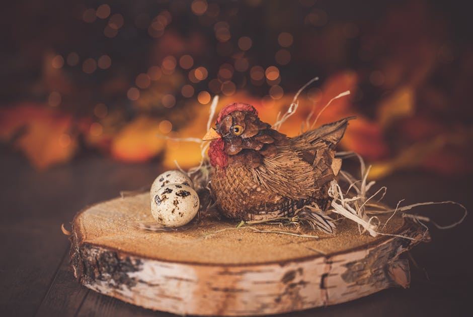 A decorative hen made of natural materials sits on a wooden slice beside two speckled eggs.