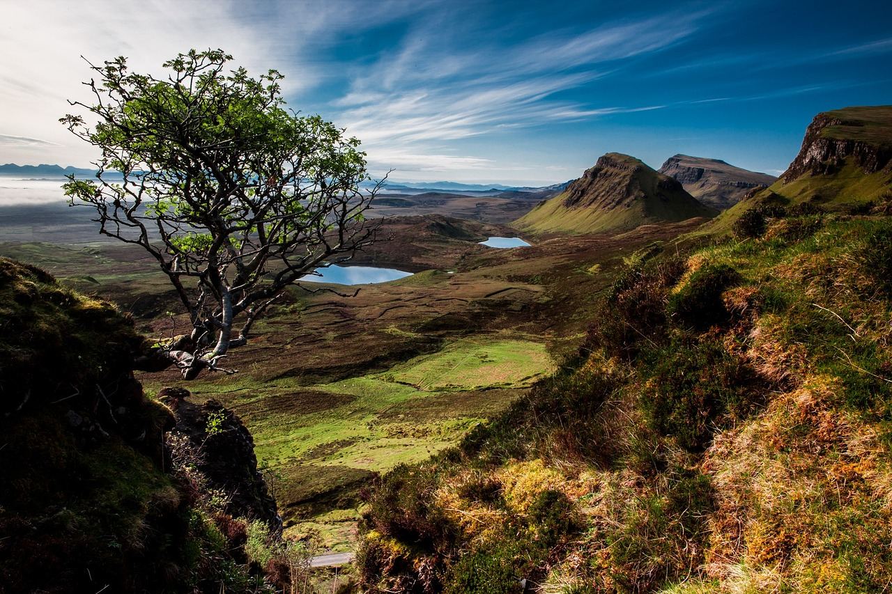 Majestic snow-capped mountains rise against a clear blue sky, inviting climbers to explore their rugged peaks.