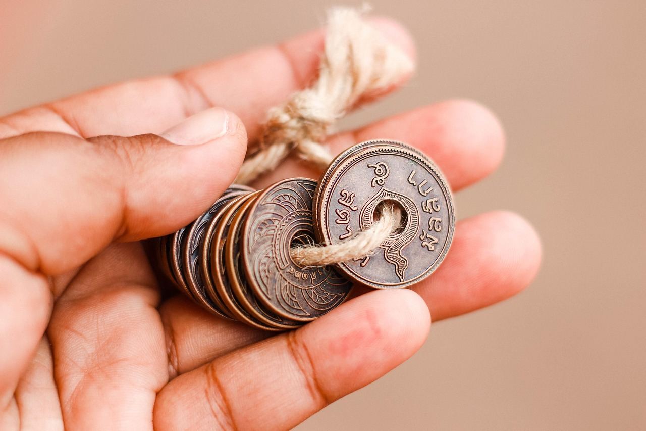 A collection of ancient coins featuring intricate designs and varying sizes, showcasing the rich history of currency.