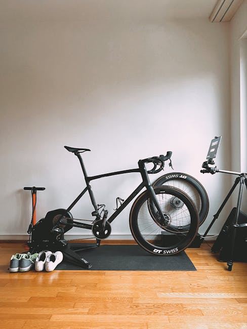 A black bicycle and cycling shoes set up indoors, perfect for indoor cycling enthusiasts.
