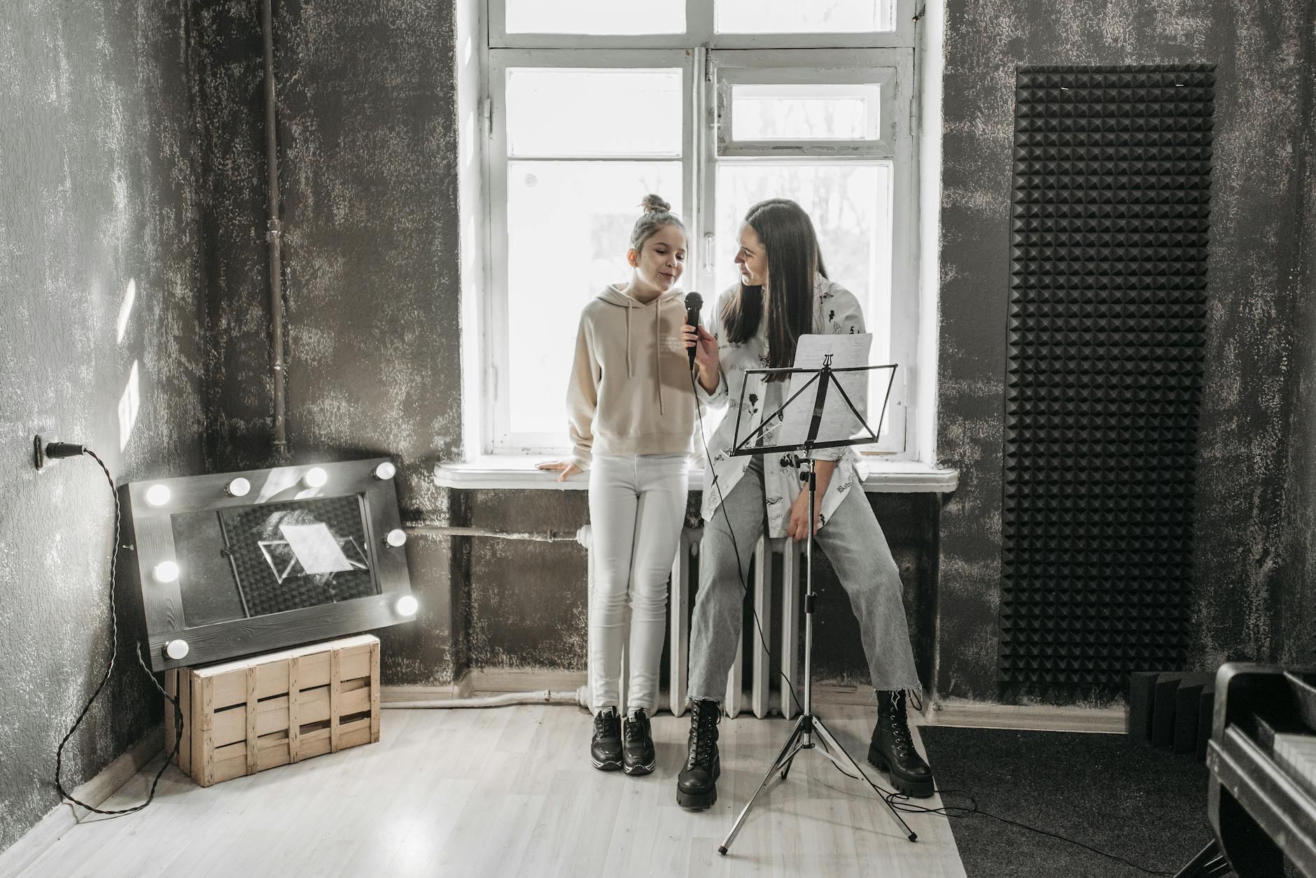 A teenager and teacher singing in a modern studio, enhancing vocal skills.