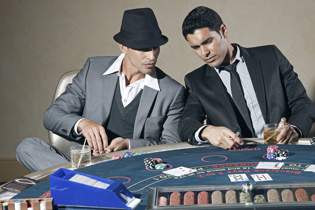 Two men strategizing at a poker table, embodying the spirit of 'Is Poker for you? Let's find out!'