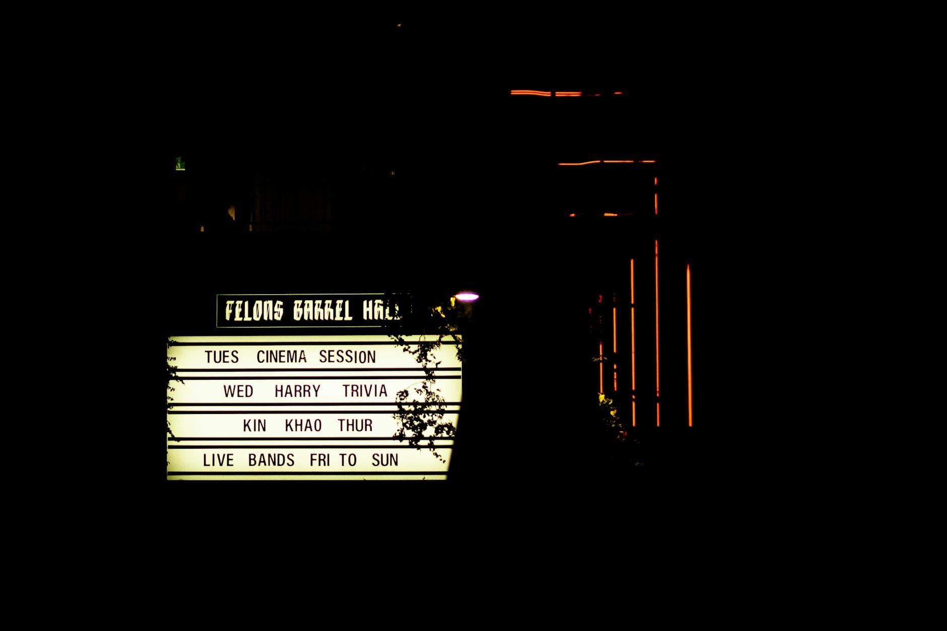 A vibrant marquee sign glows against the night sky, inviting guests to join the trivia night at Felons Barrel Hall in Brisbane.