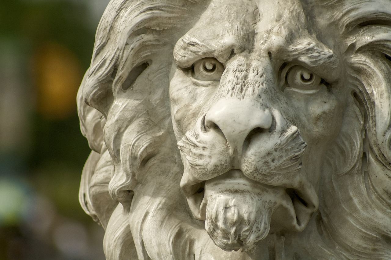 A majestic stone lion sculpture with intricate details, showcasing its powerful stance and expressive features.