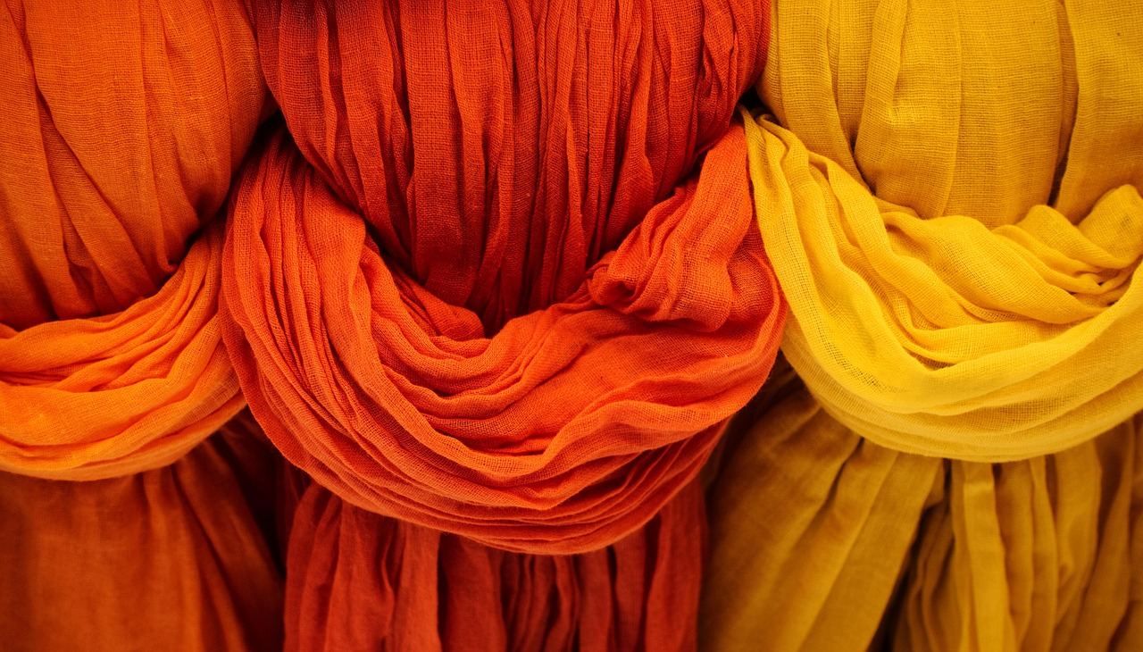 Vibrant orange and yellow fabrics, perfect for exploring fabric dyeing techniques. Is Fabric Dyeing for you? Let's find