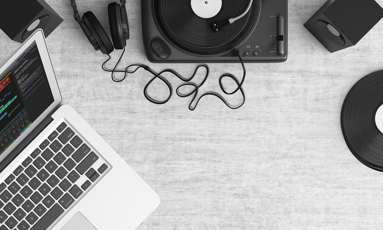 A close-up of a sleek turntable with vinyl records, showcasing intricate knobs and a spinning disc.