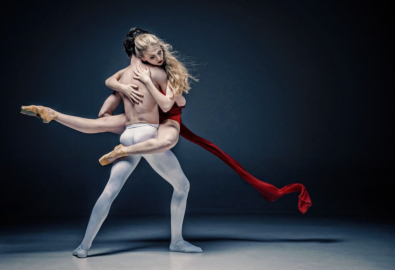 A vibrant dance studio filled with mirrors, wooden floors, and dancers gracefully moving in sync.