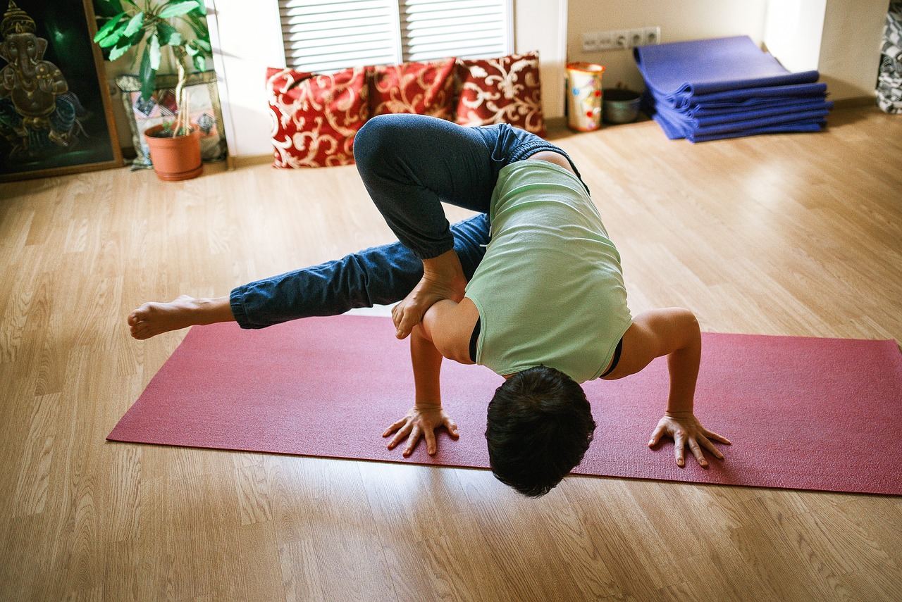 A serene yoga studio with a person practicing Hatha yoga poses on a mat, surrounded by calming natural light.