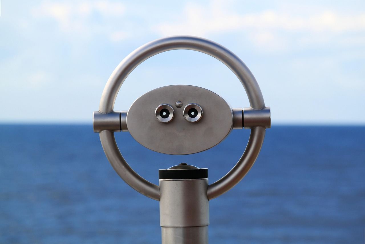 A binocular viewer overlooking the ocean, inviting exploration for those asking, 'Is Cruising for you? Let's find out!'