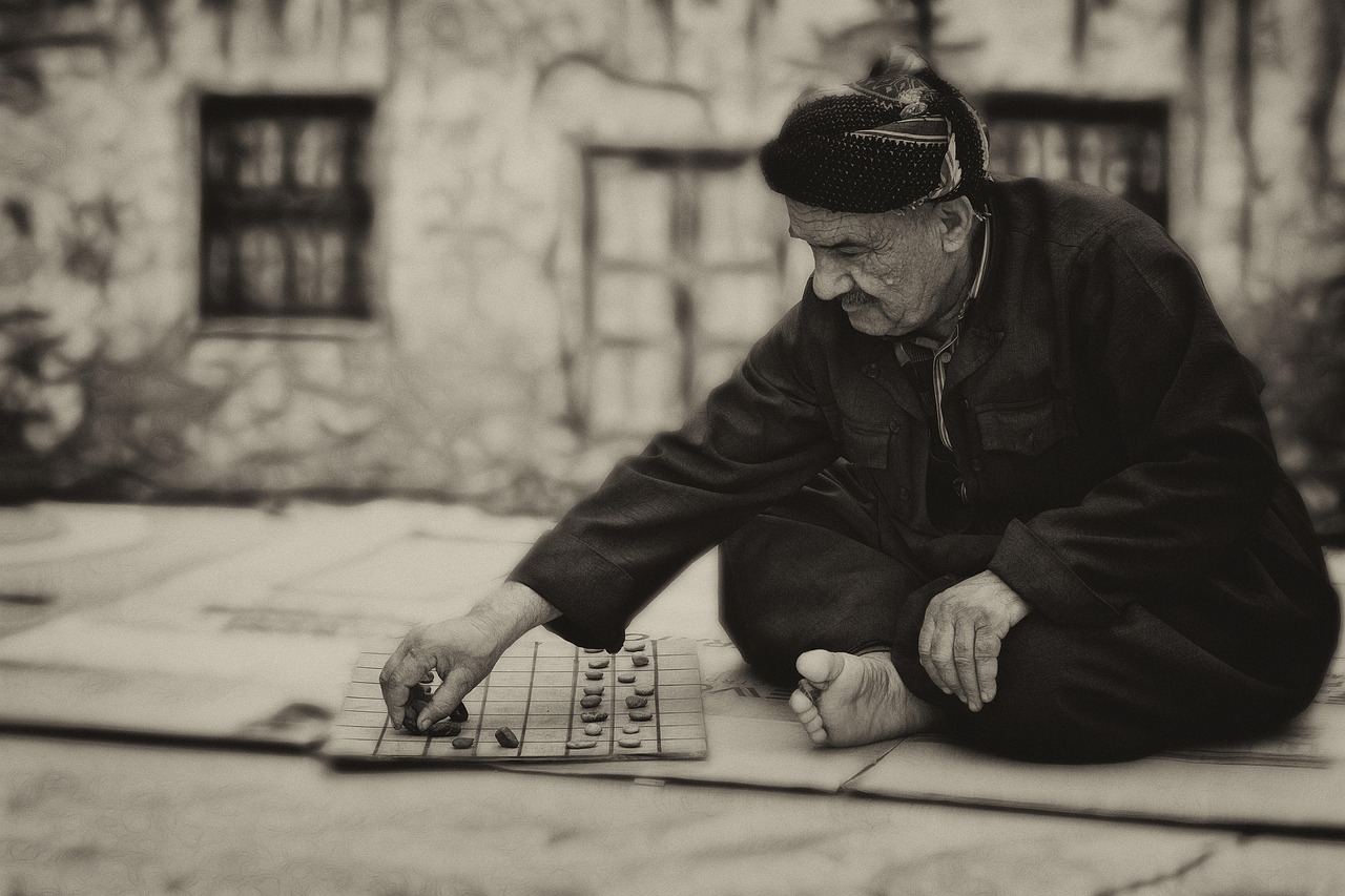 A focused man intently studying a Janggi board, contemplating his next strategic move in the ancient Korean chess game.