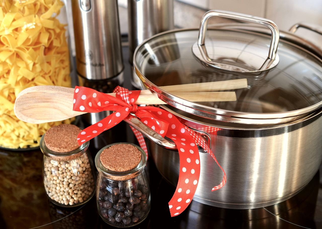 A stainless steel pot with a wooden spoon, symbolizing the joy of home cooking. Is Home Cooking for you? Let's find out!