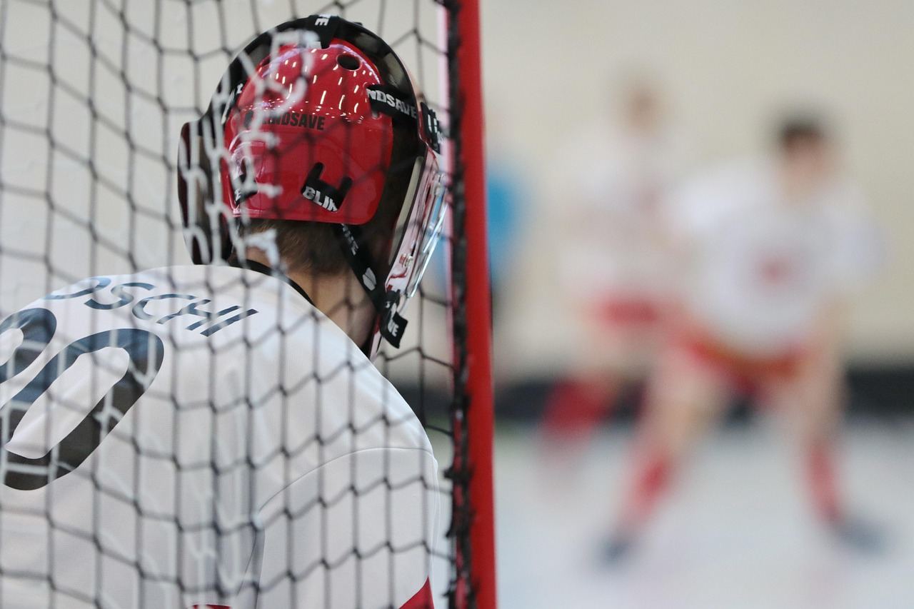 A focused floorball goalie in action, embodying the spirit of 'Is Floorball for you? Let's find out!'