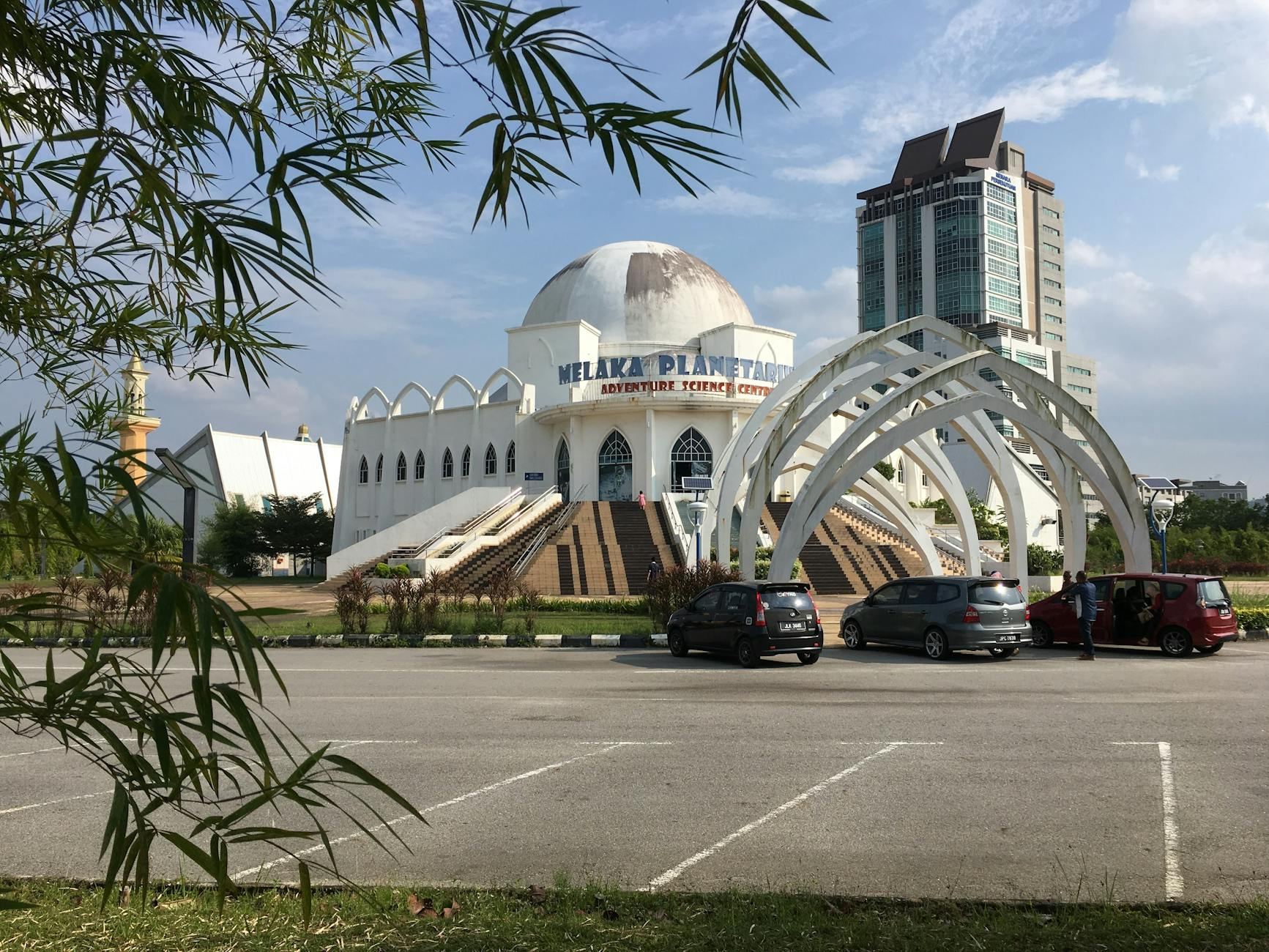 The stunning architecture of the Melaka Planetarium stands out against a clear blue sky in Ayer Keroh, Malaysia.