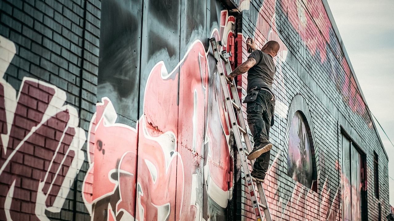 A vibrant mural showcases intricate graffiti art, featuring bold colors and dynamic designs that capture urban creativity.