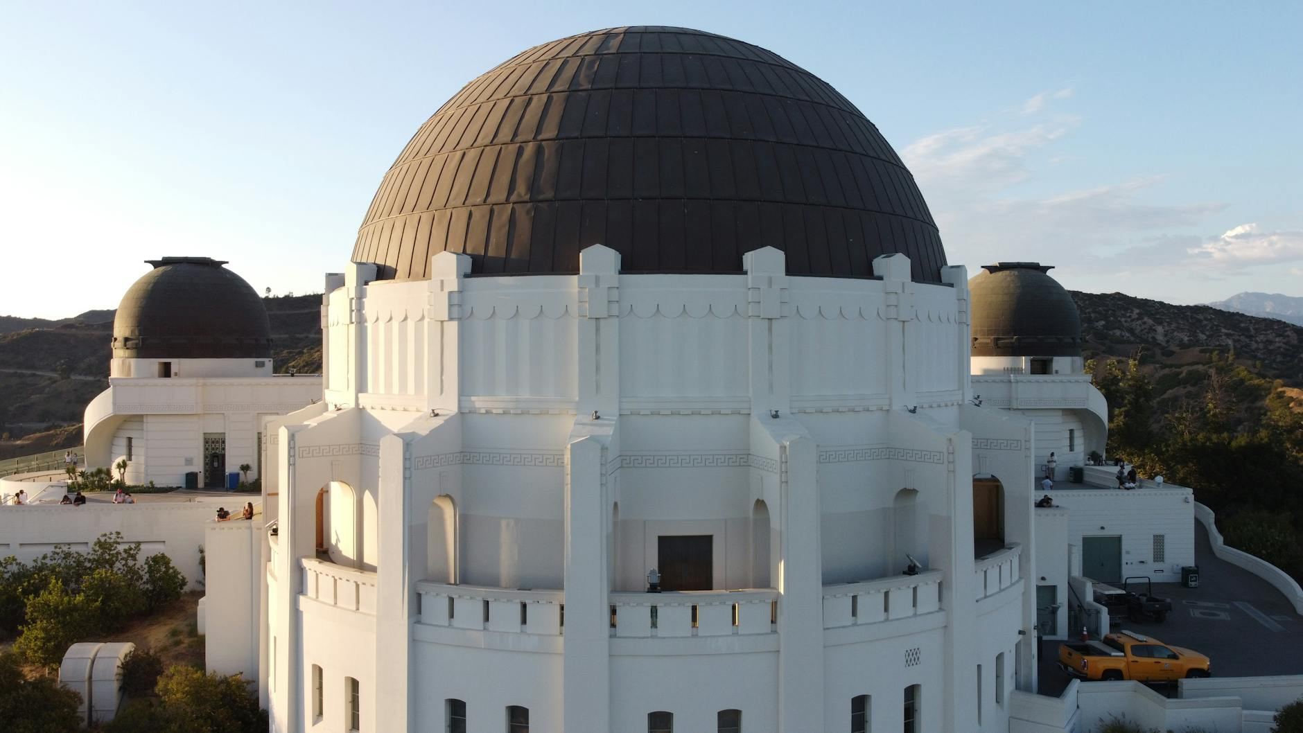 A stunning view of the Griffith Observatory in Los Angeles at sunset with scenic surroundings.