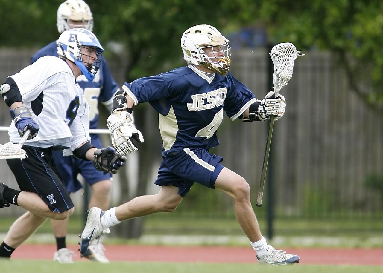 A dynamic scene capturing players in action on a box lacrosse field, showcasing intense competition and teamwork.