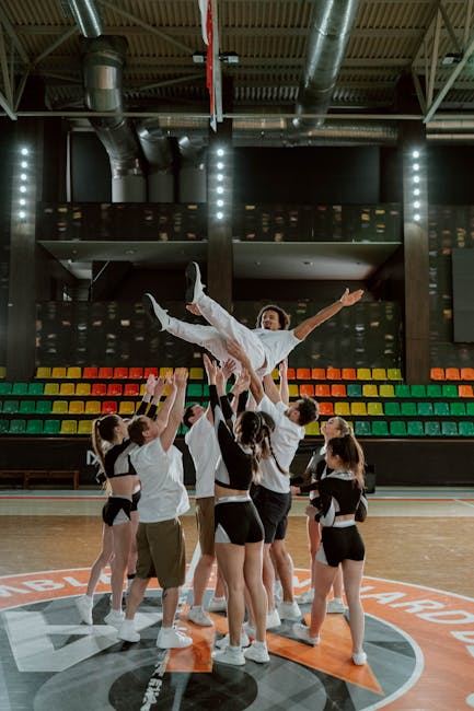 A cheerleading team performs a stunt, showcasing teamwork and athleticism, similar to Korfball dynamics.