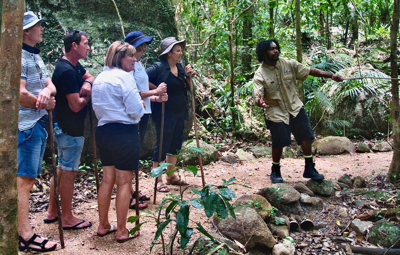 A knowledgeable tour guide enthusiastically explains local history to an engaged group of tourists in a vibrant city setting.
