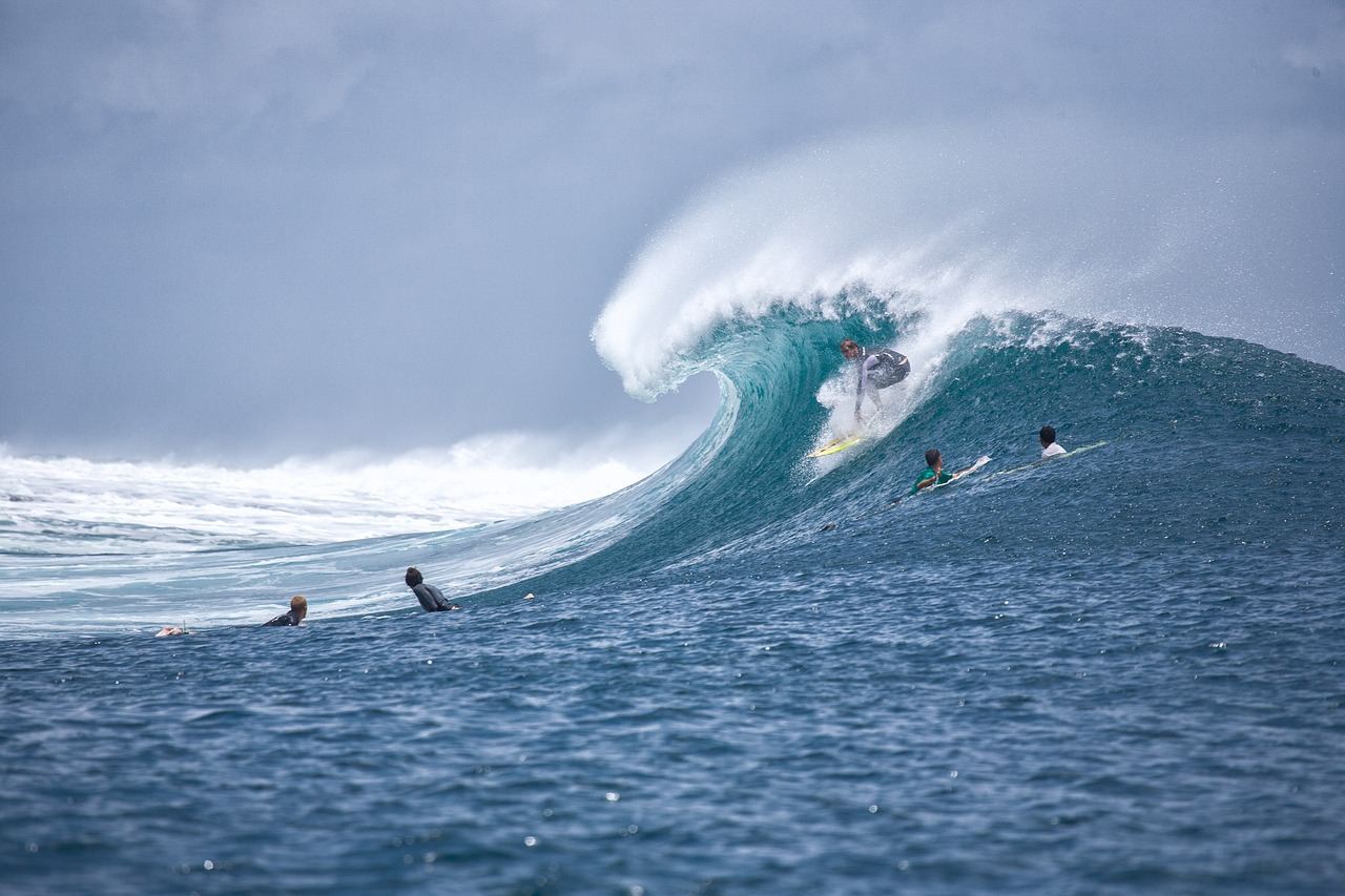 A surfer skillfully rides a vibrant wave, showcasing the thrill and excitement of the ocean sport.