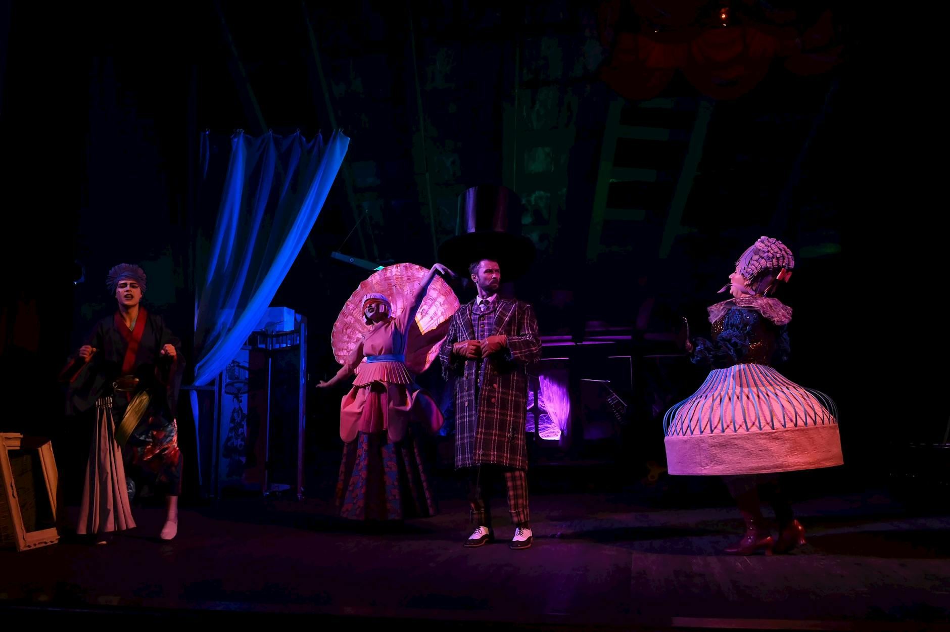 Vibrant costumes and dramatic lighting in a theatrical stage performance.