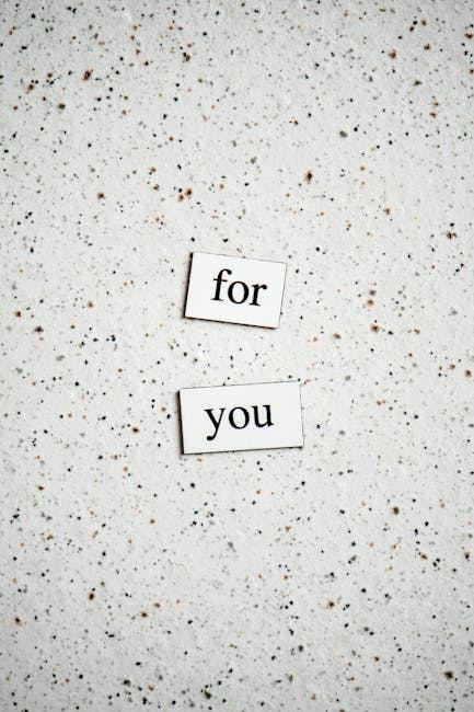 Two words 'for you' arranged on a speckled surface, representing typography design.