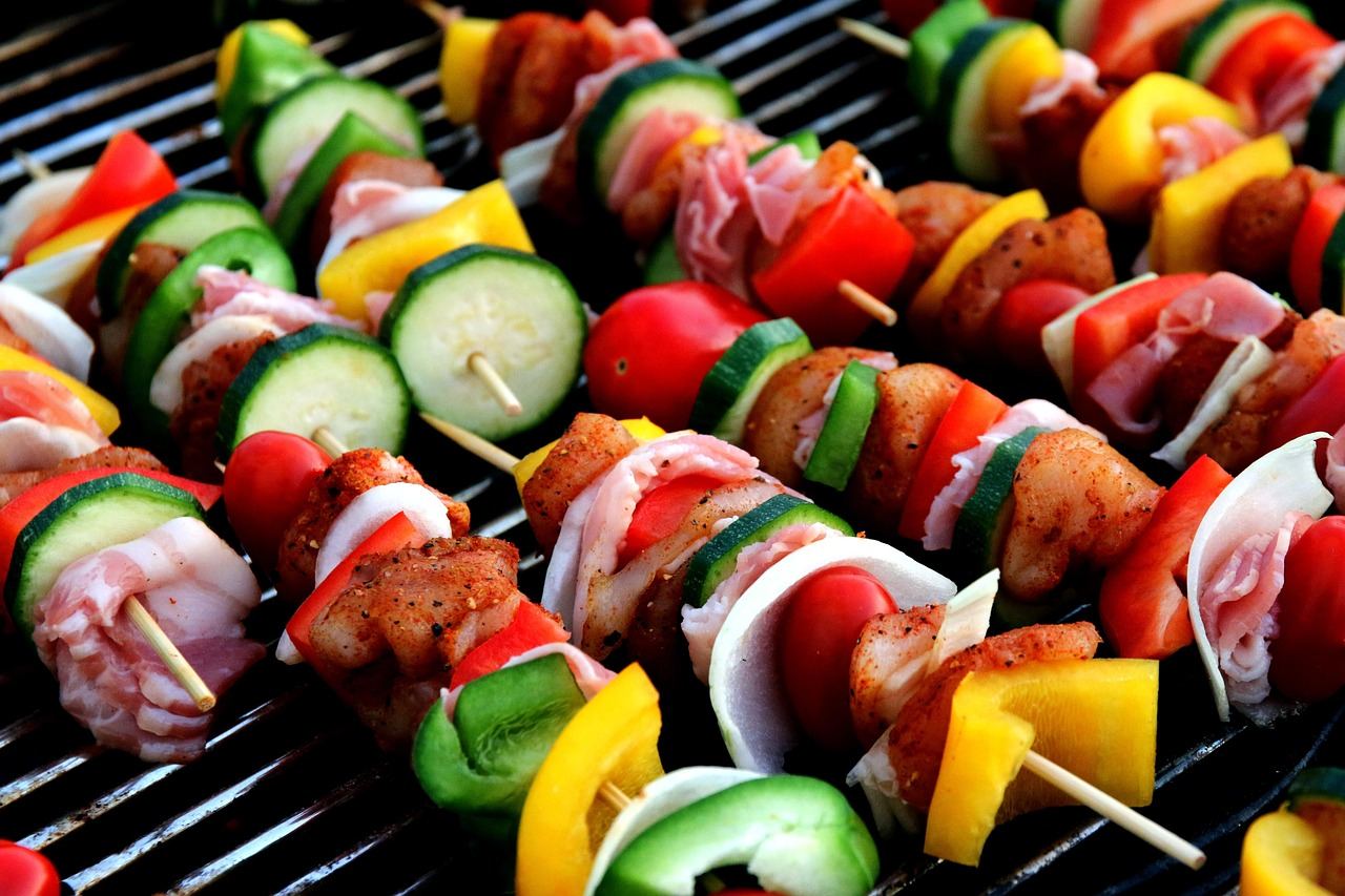 Juicy shish kebabs skewered with colorful vegetables, sizzling over a smoky grill, ready to be enjoyed.
