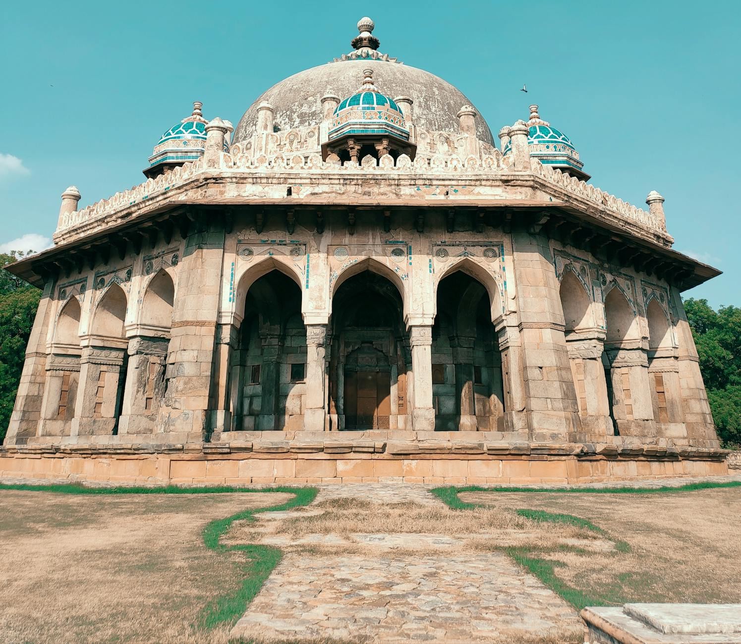 Safdarjung Tomb in Delhi features intricate stonework and stunning Mughal architecture surrounded by lush gardens.