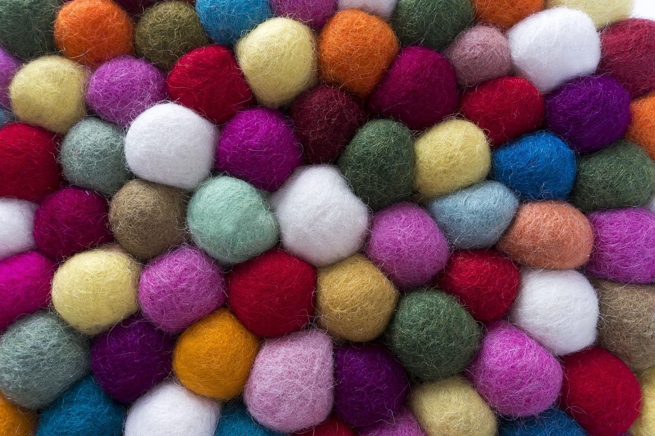 Colorful felt pieces in various shapes and textures, showcasing the vibrant possibilities of the felting hobby.
