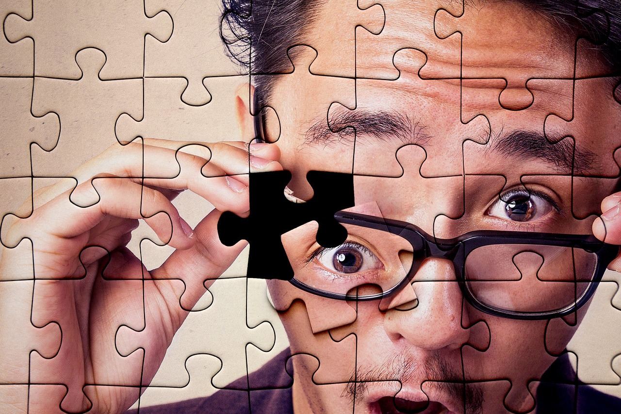 A man looks surprised while holding a jigsaw puzzle piece, exploring 'Is Jigsaw Puzzles for you? Let's find out!'