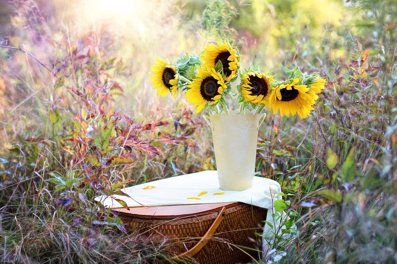 A vibrant arrangement of sunflowers in a rustic vase, showcasing their bright yellow petals and green leaves.