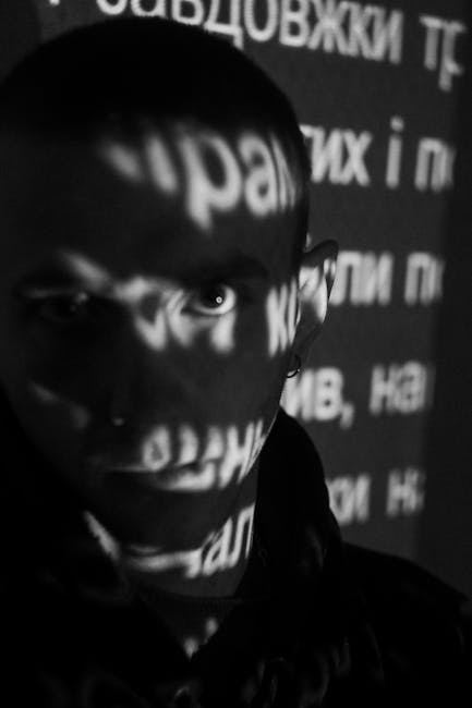A person with projected text shadows on their face, illustrating the concept of projection mapping.