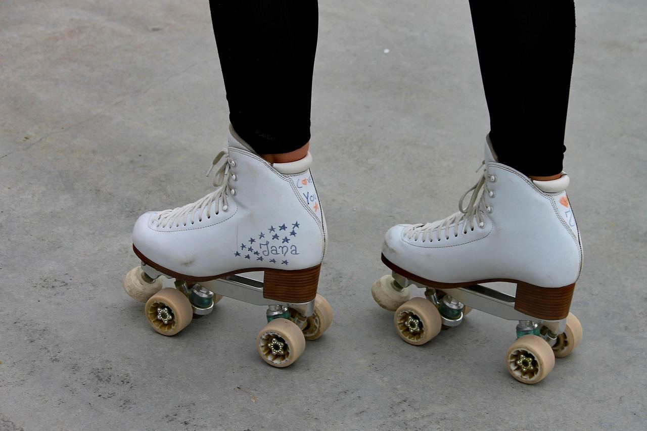 Colorful roller skates lined up on a wooden floor, ready for an exciting skating session at the rink.
