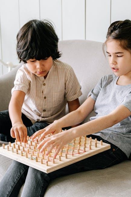 Two children playing a board game together, showcasing cooperation and engagement in gaming.