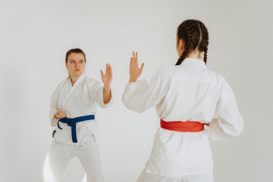 Two martial artists practicing Hapkido techniques in traditional uniforms, showcasing stances and focus.