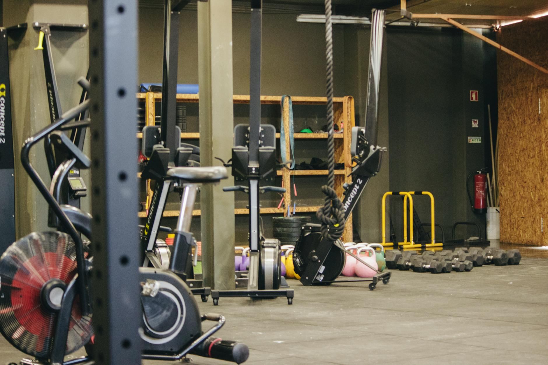 A vibrant indoor gym filled with diverse exercise equipment and weights, inviting participants to engage in an energetic workout.