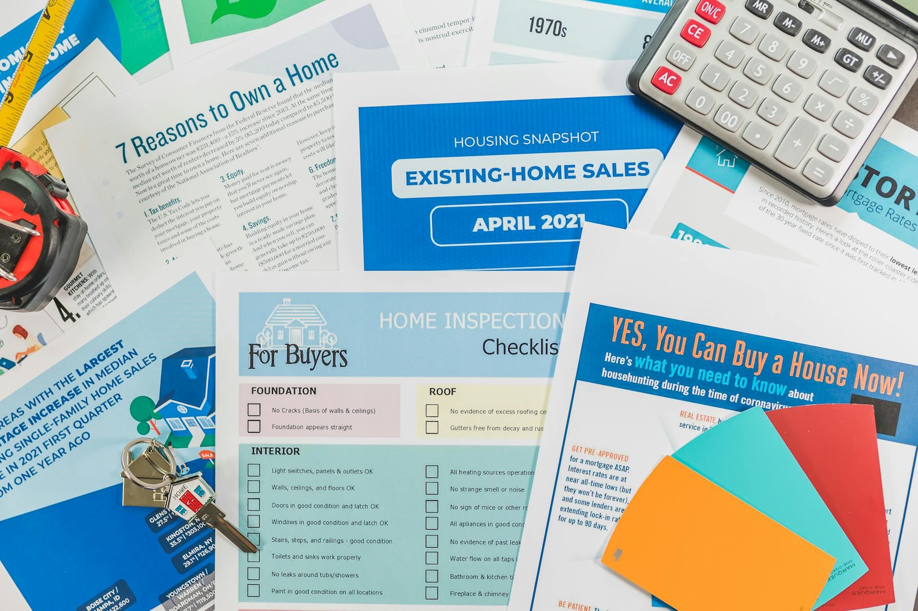 A flat lay arrangement featuring camping checklists, brochures, and a calculator, emphasizing preparation for outdoor adventures.