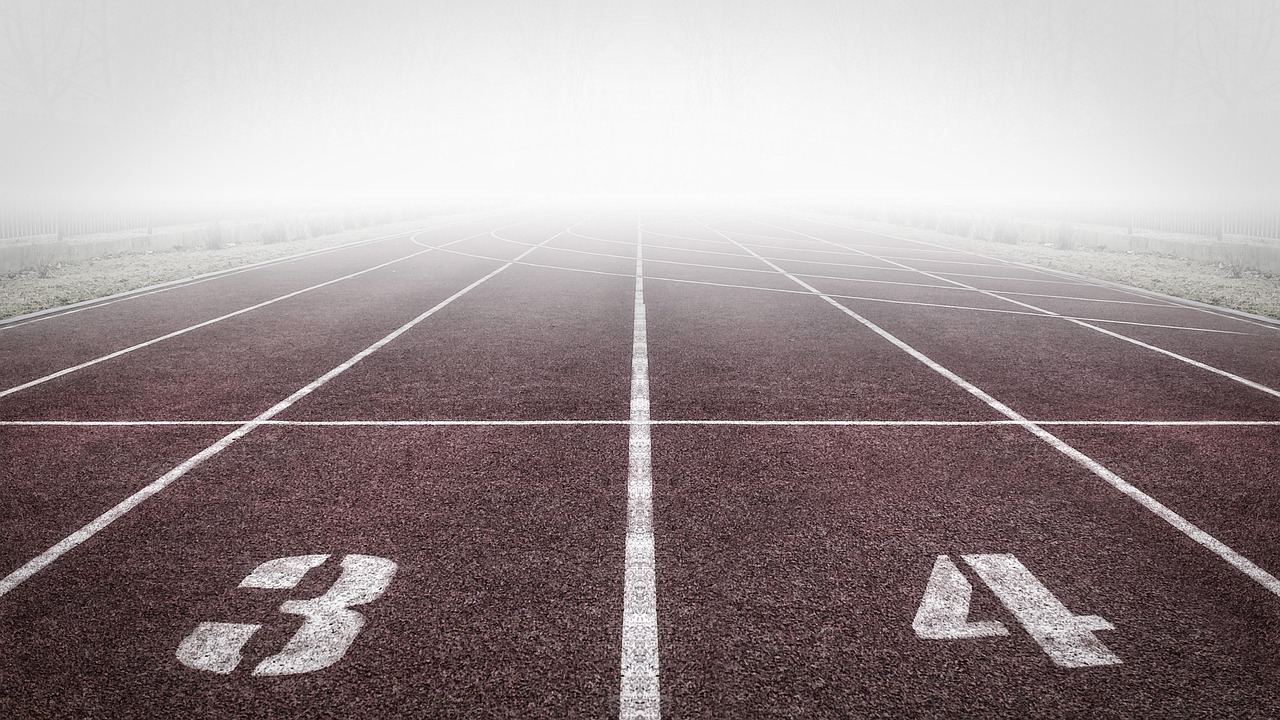 A foggy running track with lanes 3 and 4, perfect for exploring if sprint training is for you.