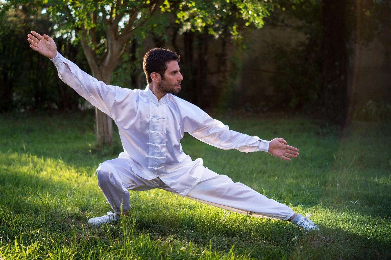 A man practicing Tai Chi outdoors, showcasing balance and focus. Is Tai Chi Martial Arts for you? Let's find out!