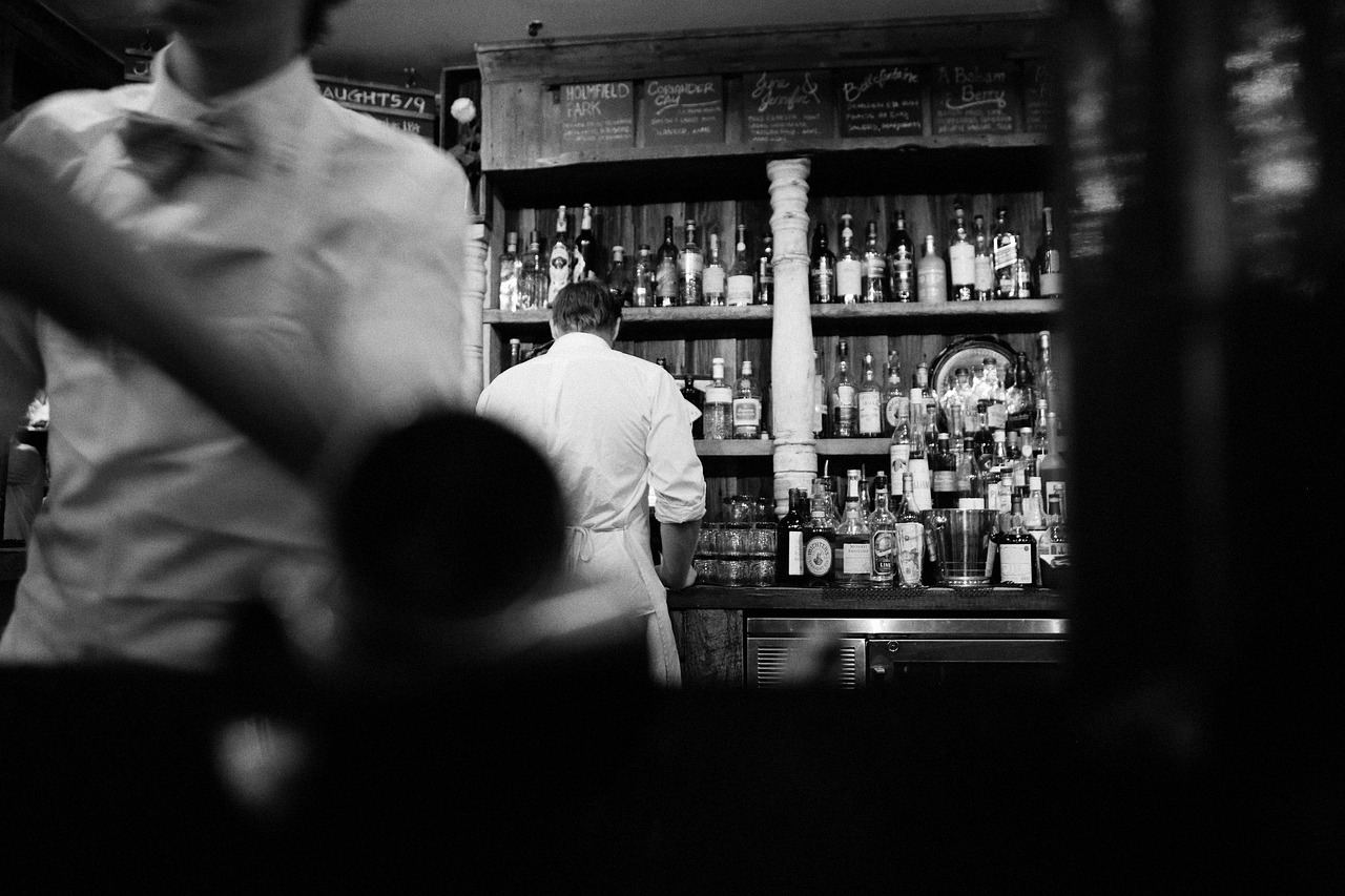 A bartender prepares drinks at a bar, showcasing the art of mixology. Is Mixology for you? Let's find out!