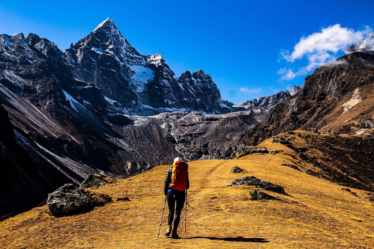 A hiker traverses a rugged mountain landscape, embodying the spirit of day hiking. Is Day Hiking for you? Let's find out