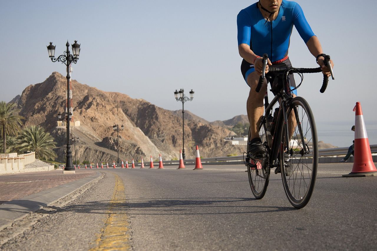 A cyclist rides on a winding road, showcasing the thrill of road cycling. Is Road Cycling for you? Let's find out!