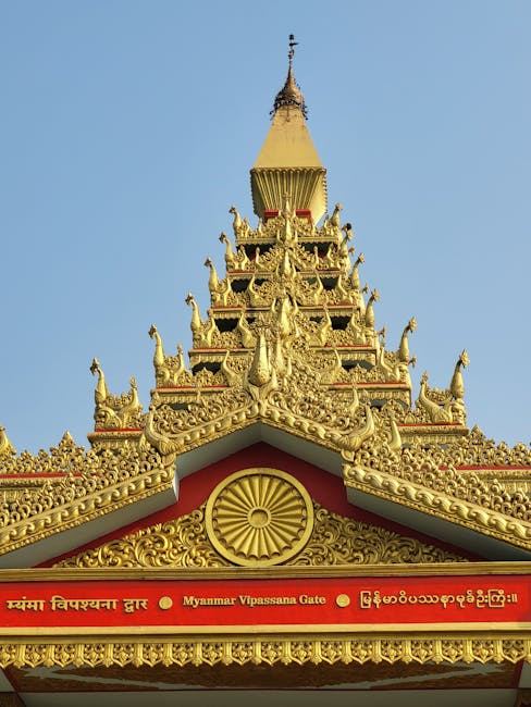 Golden Myanmar Vipassana Gate with intricate designs, symbolizing meditation and mindfulness.