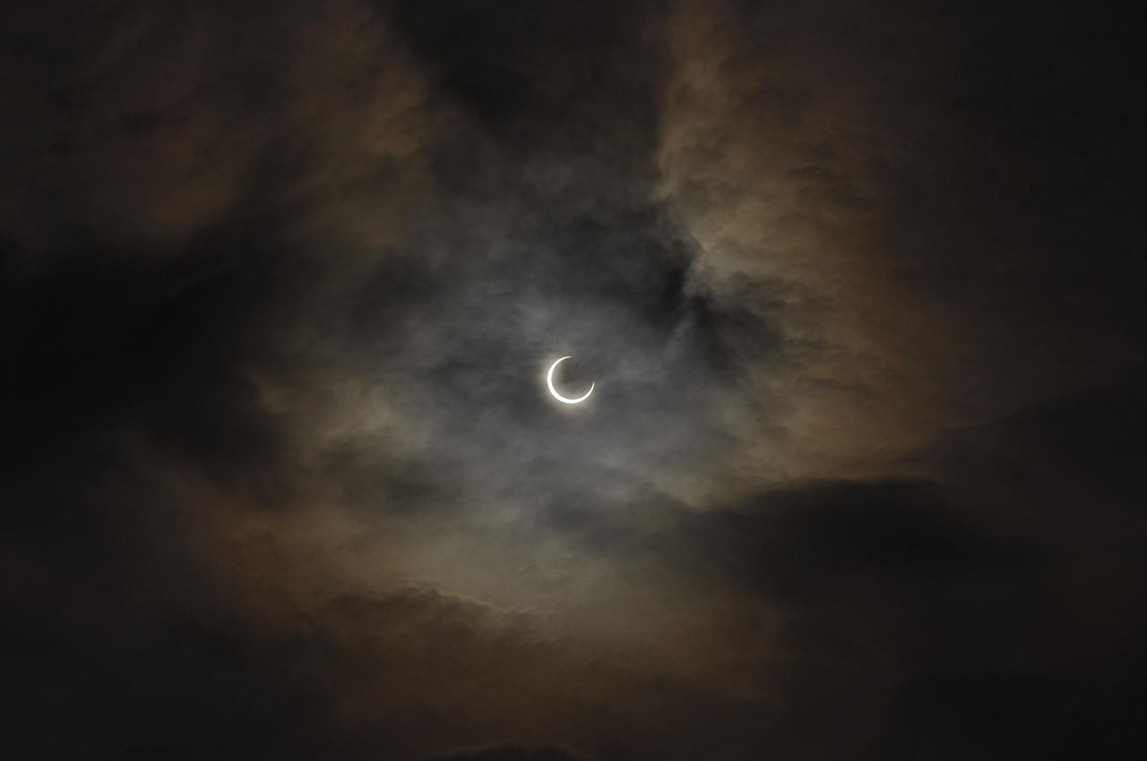 A partial solar eclipse partially obscured by clouds, perfect for eclipse chasing enthusiasts. Is Eclipse Chasing for yo