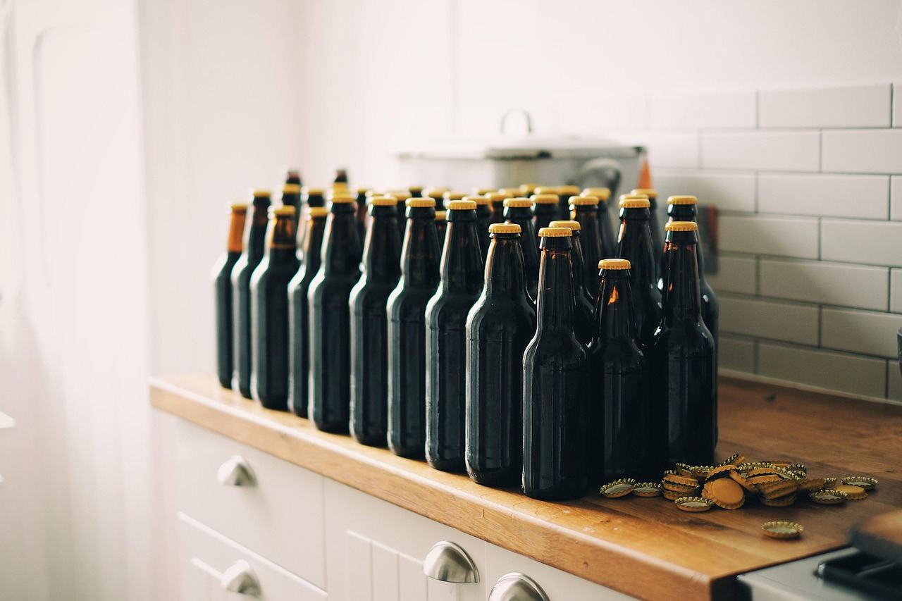 A row of dark glass bottles filled with home-brewed beer, perfect for exploring 'Is Home Brewing for you? Let's find out