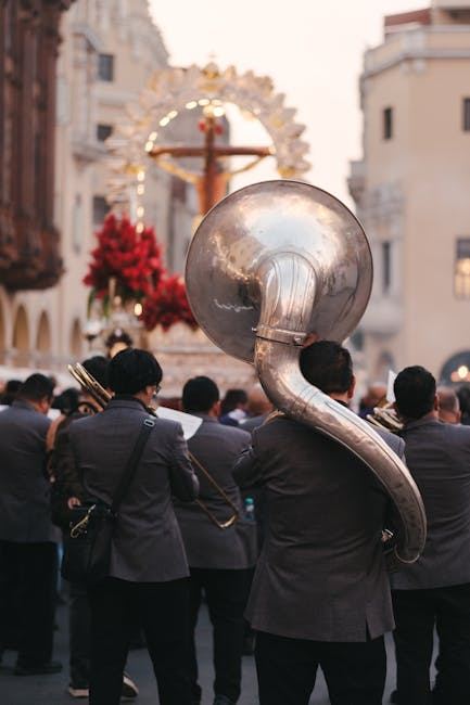 A group of musicians playing tubas during a parade, showcasing the instrument in a lively setting.